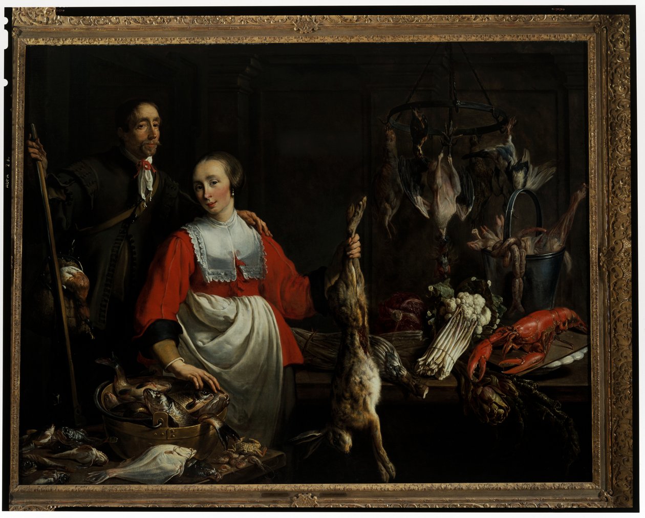 Un guardabosque con una escopeta de caza y una criada sosteniendo una liebre muerta en una despensa. de Adriaen van Utrecht