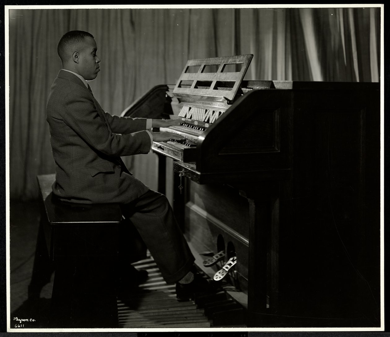 Hombre afroamericano tocando el órgano en la Asociación para Ciegos de Nueva York, 111 East 59th Street, Nueva York, 1934 de Byron Company