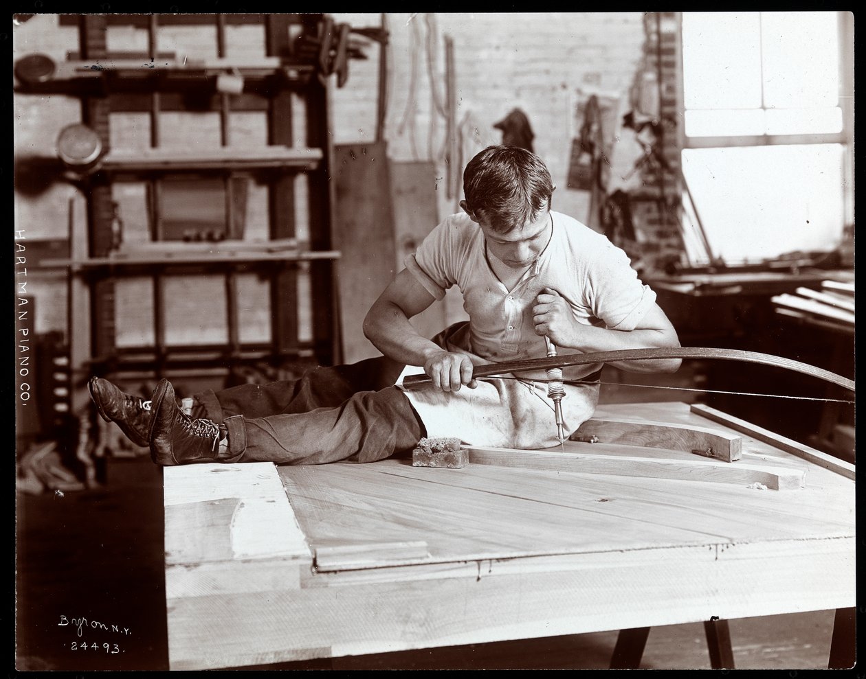 Un hombre trabajando en la fábrica de Hartman Piano Co. de Byron Company