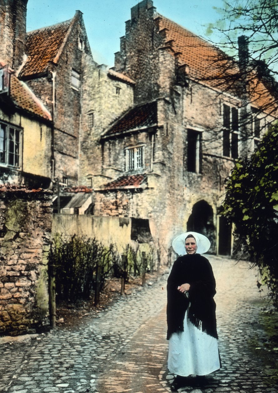 Países Bajos, provincia de Zelanda. Mujer delante del portal de Kuipers en la ciudad de Middelburg. Fecha de la imagen: hacia 1920. Archivo Carl Simon de Carl Simon