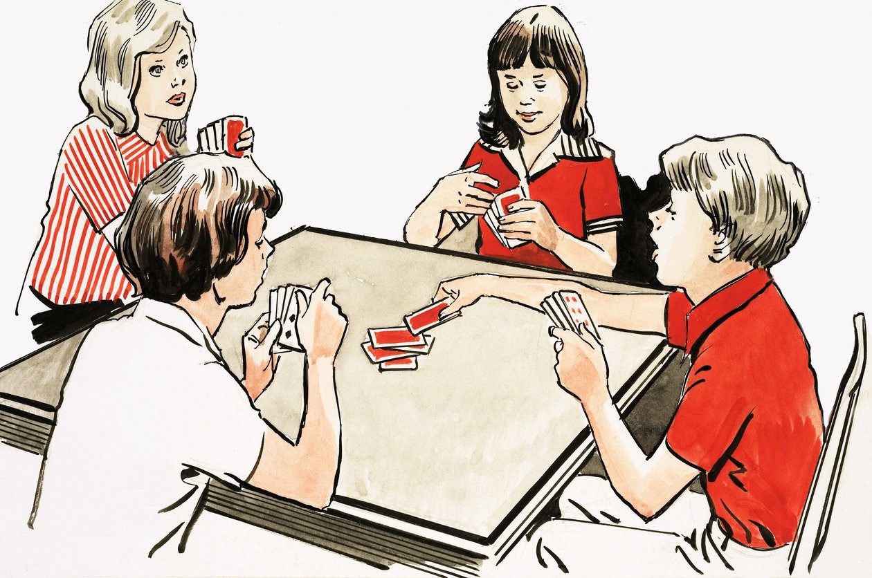 Cuatro niños jugando a las cartas de English School