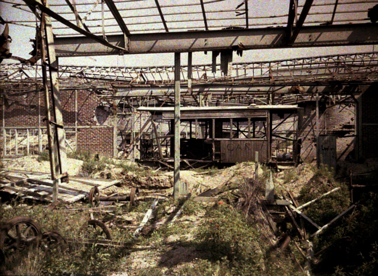 El patio de ferrocarriles y tranvías quemado con algunos vehículos dañados y una locomotora, Soissons, Aisne, Francia, 1917 de Fernand Cuville