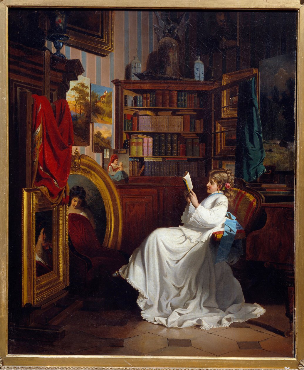 Niña leyendo un libro en una oficina de French School