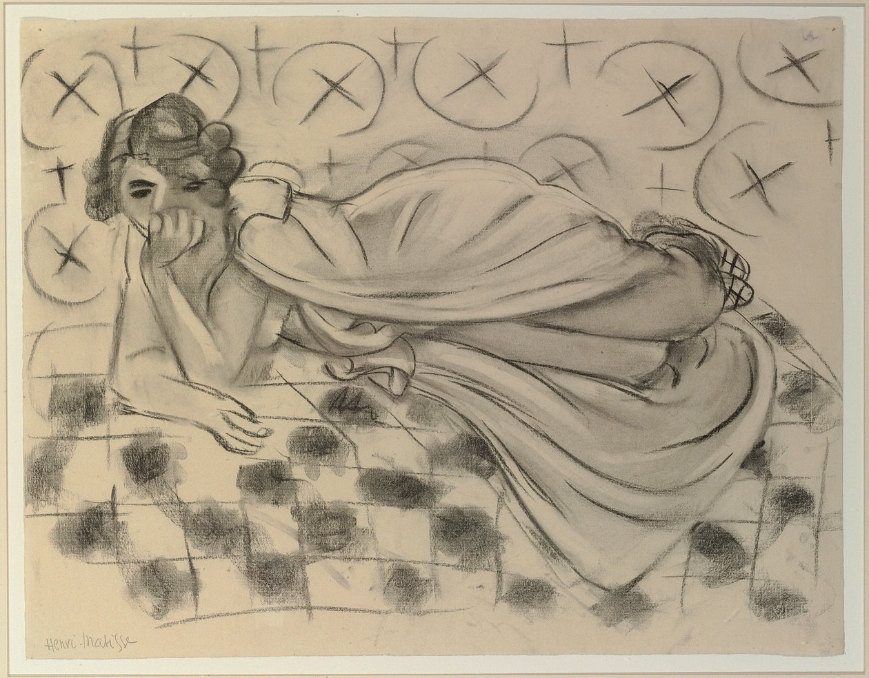 Figura drapeada tumbada en un sofá negro a cuadros de Henri Matisse