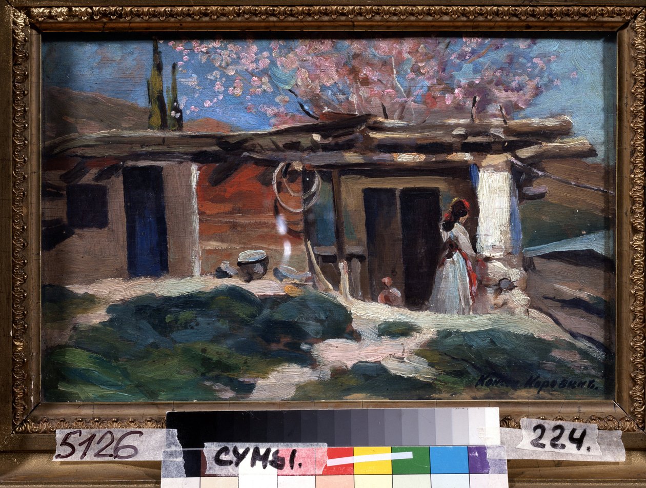 Crimea, almendros en flor. (Crimea, Almendros en flor). Mujer joven frente a una pequeña casa de madera, bajo almendros rosas. Pintura de Konstantin Alexeyevich Korovin (Constantin Korovin) (1861-1939), óleo sobre lienzo de Konstantin Alekseevich Korovin