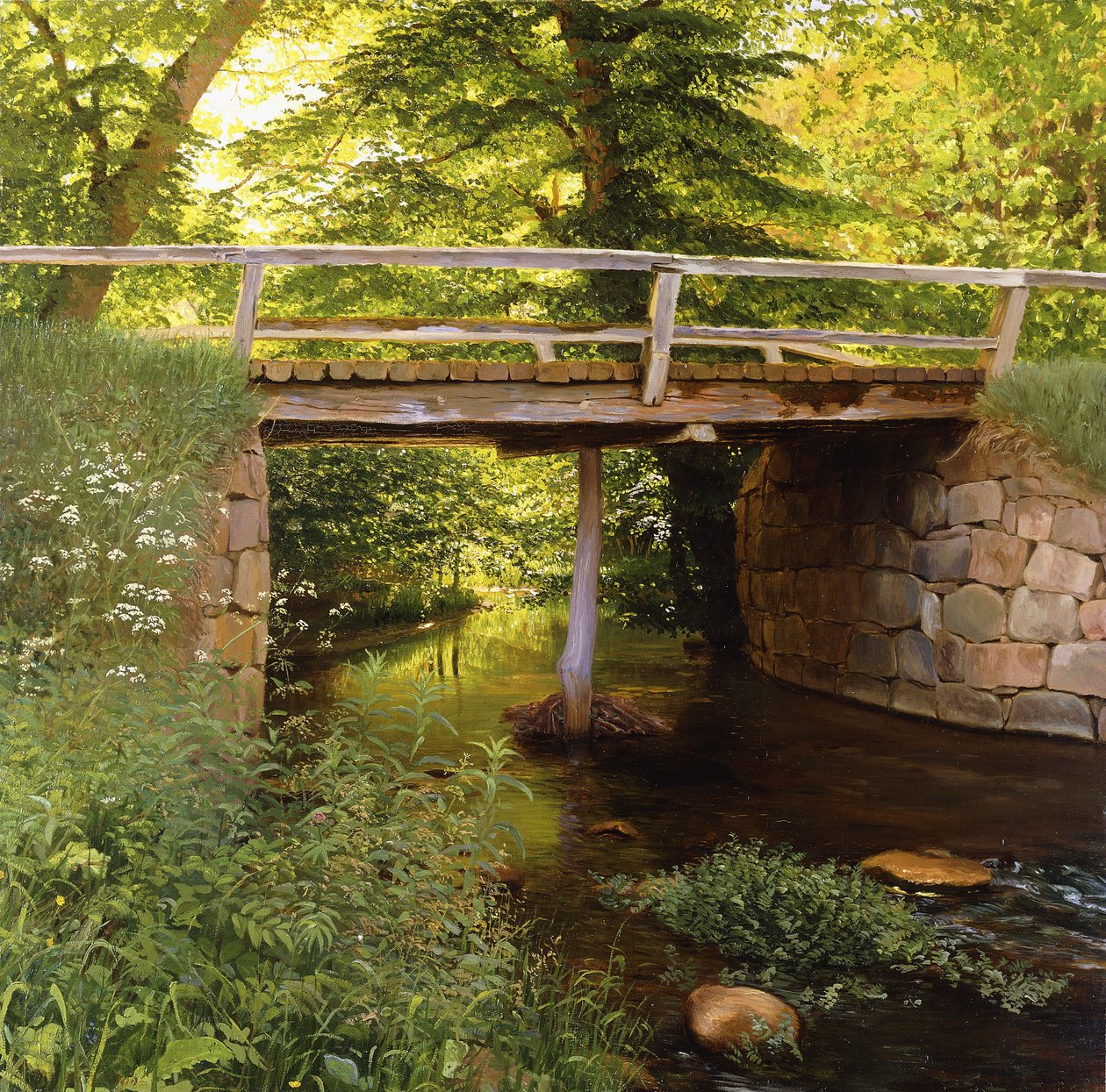 Un arroyo en el bosque con un puente de madera de Marcus Bech Fritz