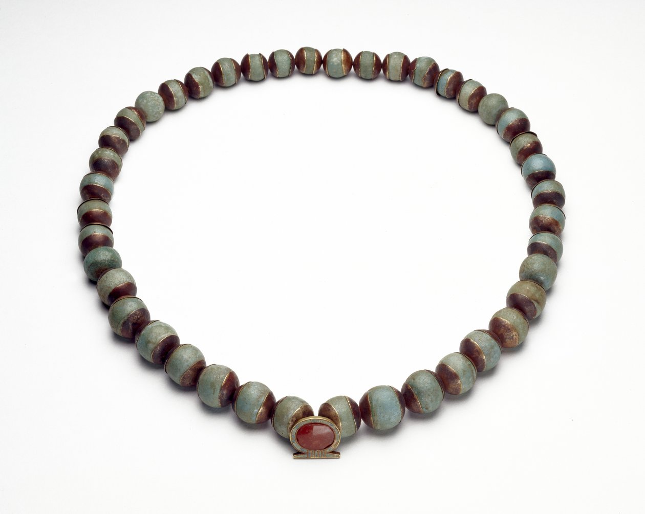 Cilindro de fayenza y collar con colgante de oro, turquesa y cornalina en forma de anillo shen, el signo de la eternidad de Middle Kingdom Egyptian