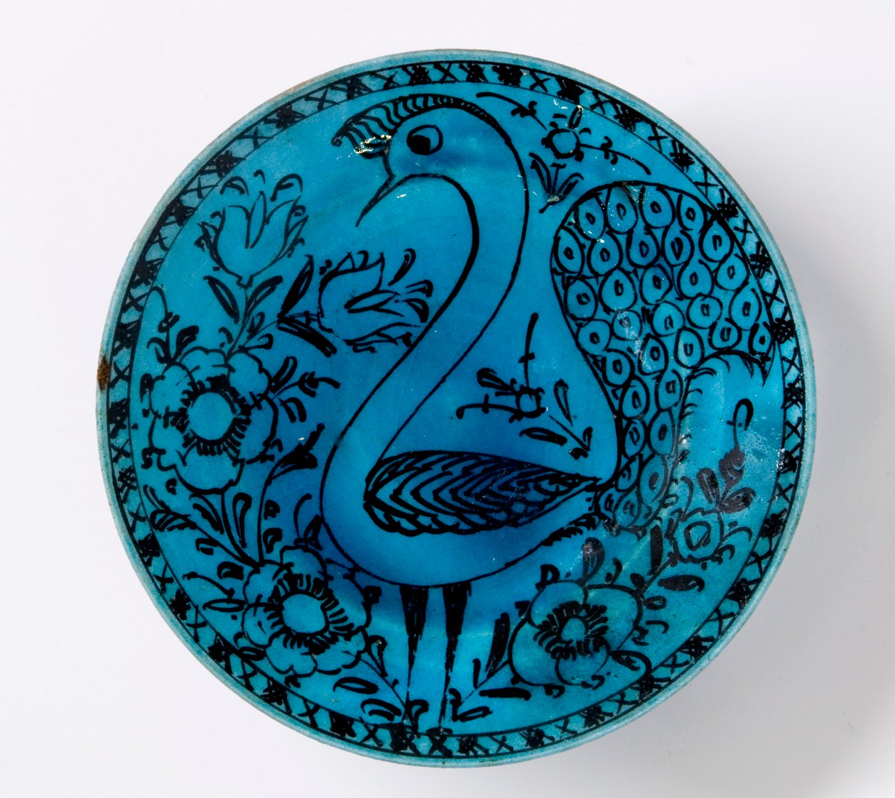 Plato de cerámica persa del siglo XIX que representa un pavo real sobre un fondo turquesa de Persian School