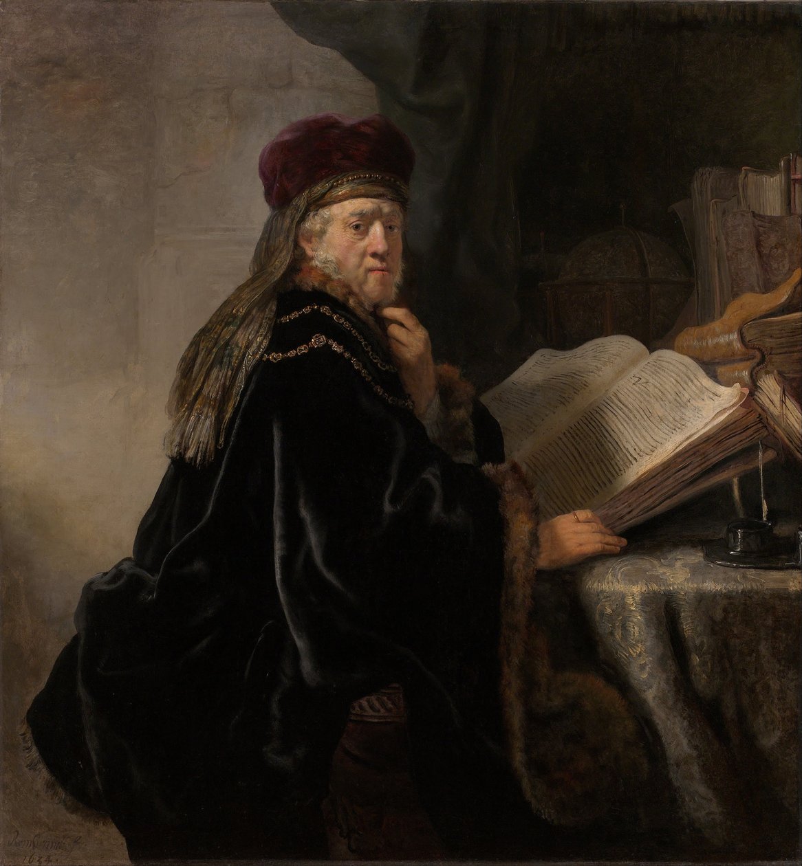 Un erudito sentado en un escritorio de Rembrandt van Rijn
