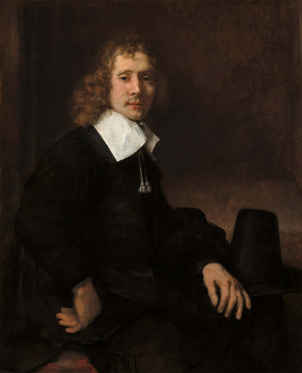 Un joven sentado en una mesa posiblemente Govaert Flinck, c. 1660 de Rembrandt van Rijn