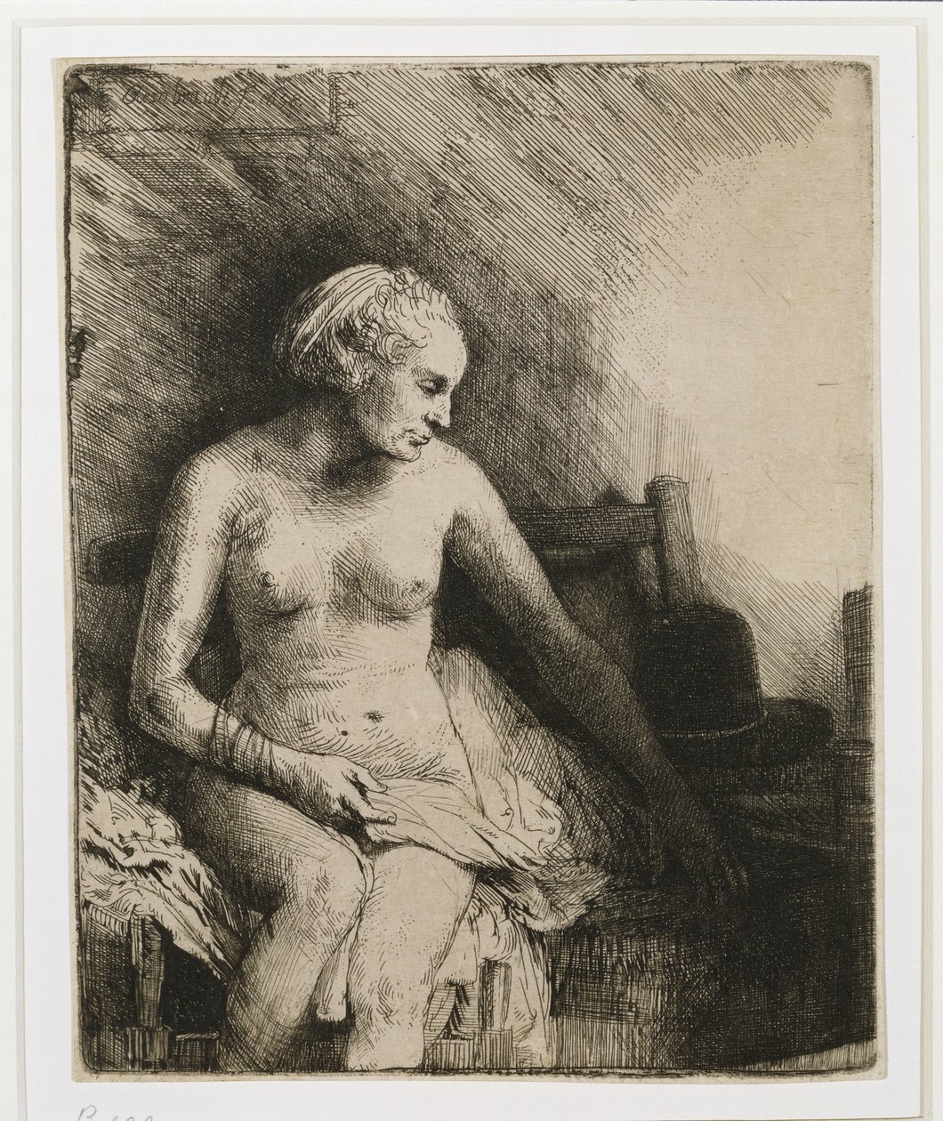 Una mujer en el baño con un sombrero a su lado, 1658 de Rembrandt van Rijn