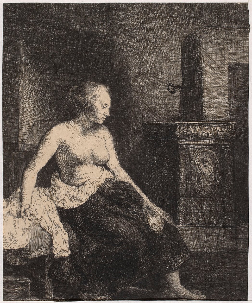 Una mujer semidesnuda sentada junto a la estufa de Rembrandt van Rijn