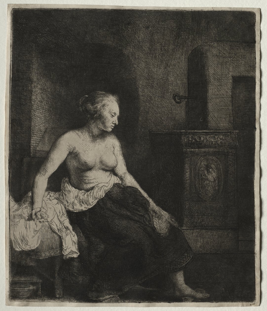 Mujer sentada medio vestida junto a una estufa de Rembrandt van Rijn