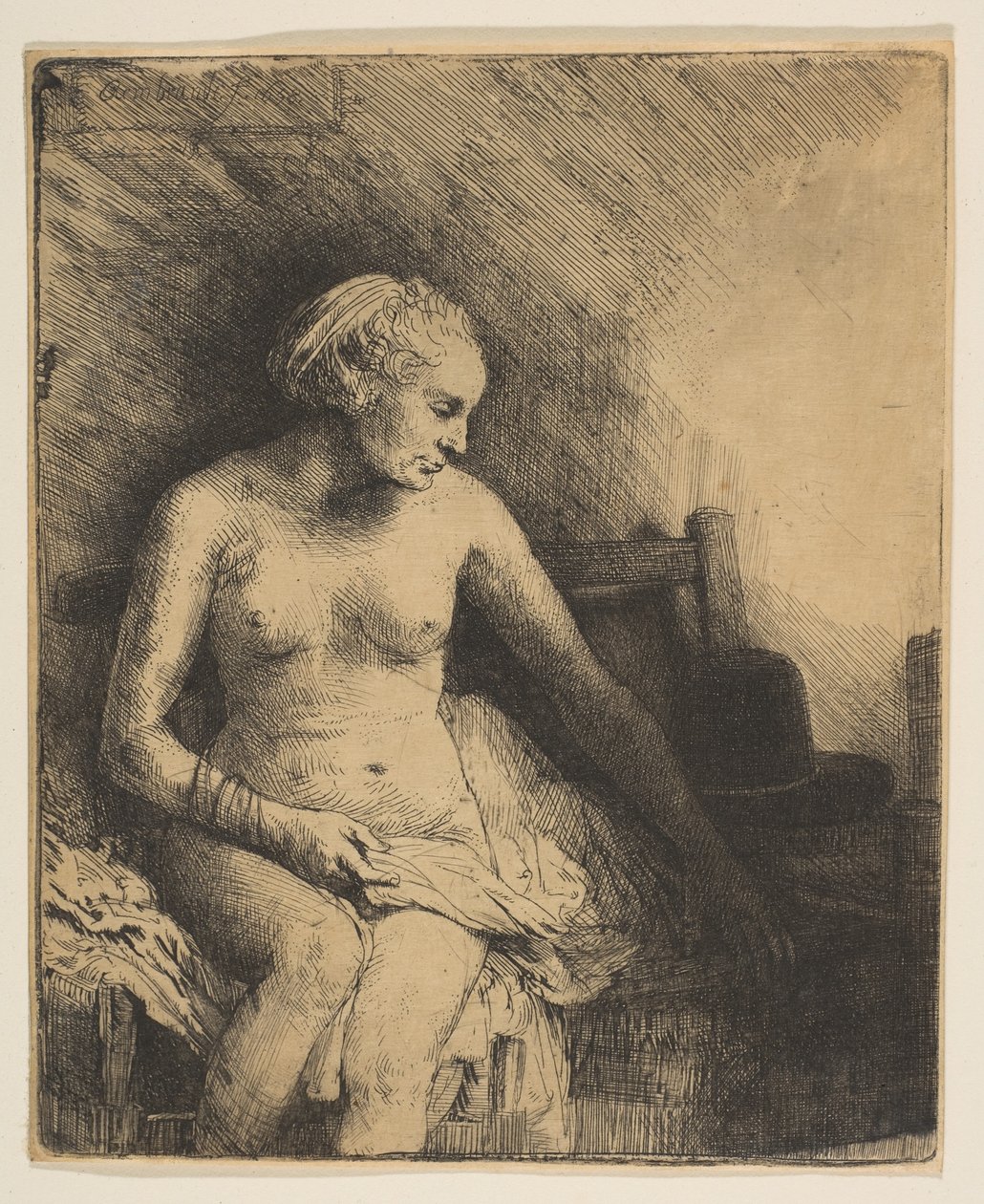 Mujer en el baño con un sombrero a su lado de Rembrandt van Rijn
