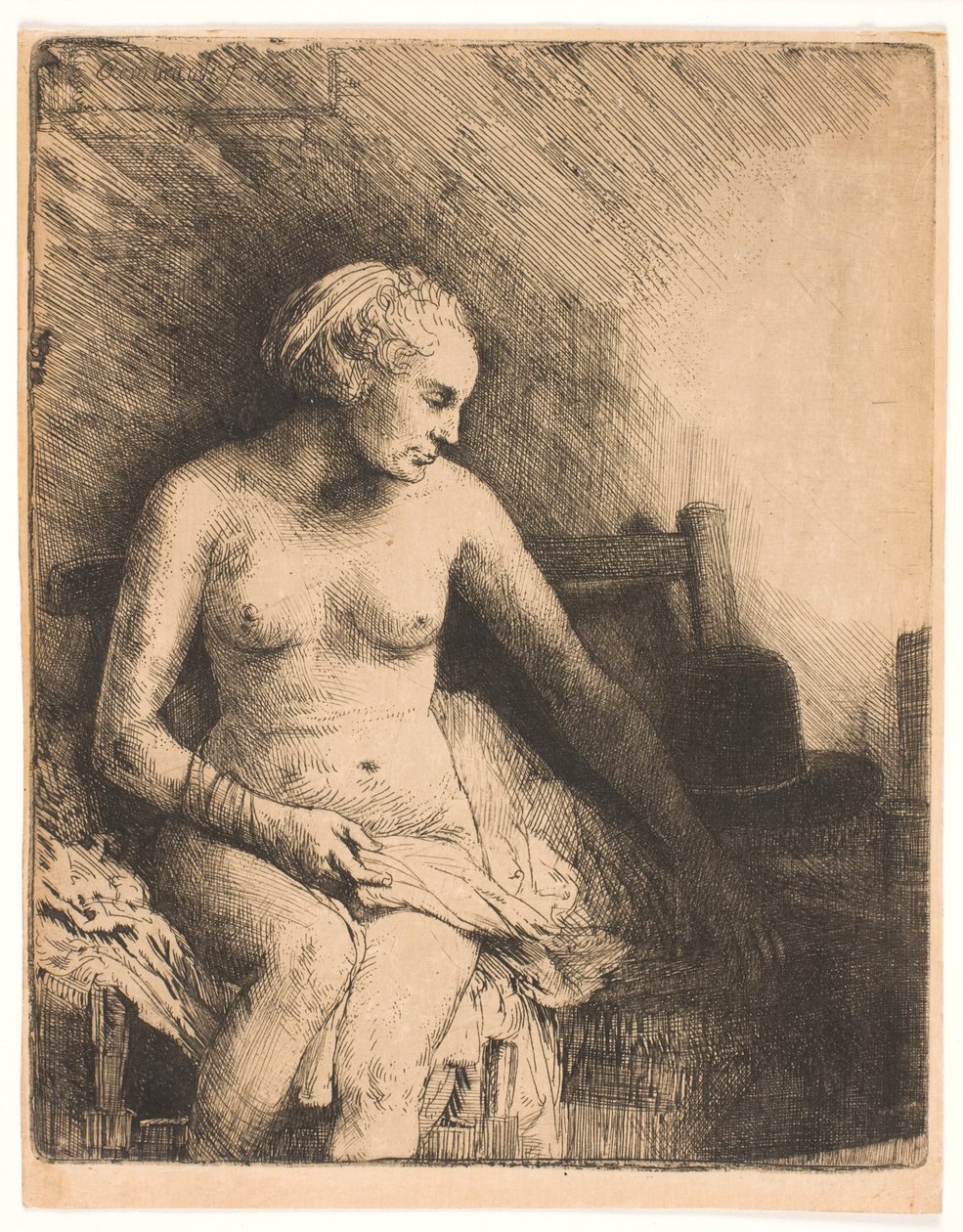 Mujer en el baño, con un sombrero a su lado de Rembrandt van Rijn