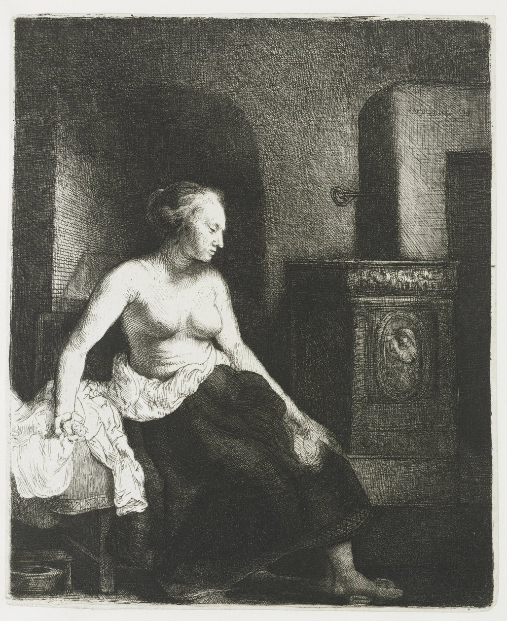 Mujer sentada a medio vestir junto a una estufa de Rembrandt van Rijn