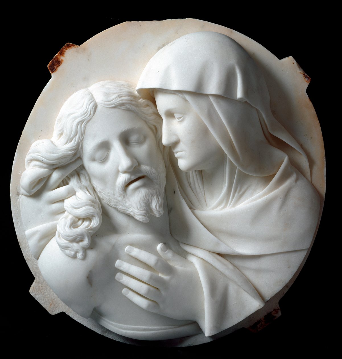 Piedad Escultura de mármol de Santo Varni (1807-1885) 1863-1870. Dim. 56x52x12 cm De la colección del Príncipe Odon di Savoia. Génova, Galleria d