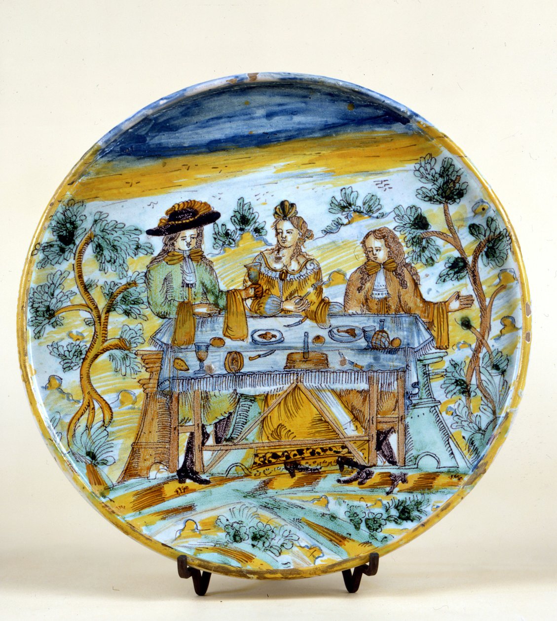 Representación de un banquete al aire libre en un plato de cerámica de Talavera de la Reina (España). Principios del siglo XVI. Milán, Museo del Castello. de Spanish School