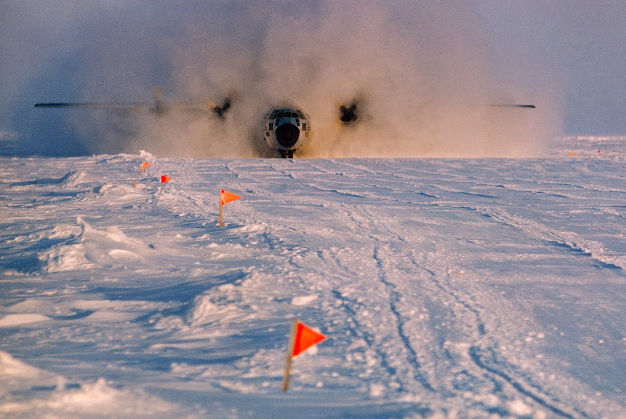 Oscurecido por el humo, un avión de abastecimiento aterriza en la pista de Arlis II. de Ted Spiegel