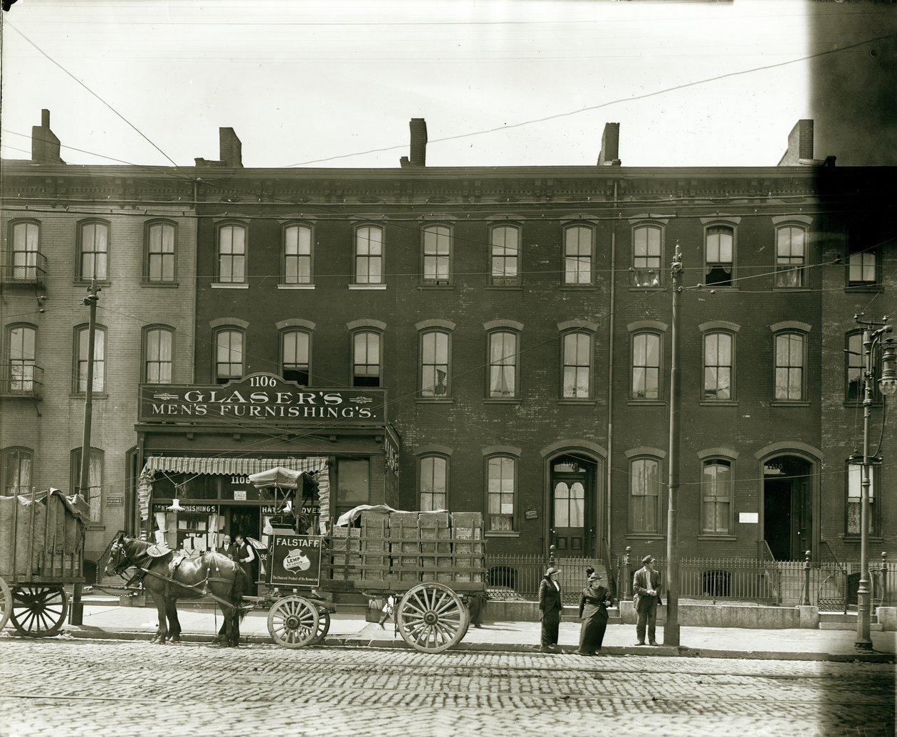 Vista de la tienda de ropa para hombres de Glaser en 1106 Chouteau Avenue con un carro de reparto de cerveza Lemp-Falstaff cargado al frente de Unknown