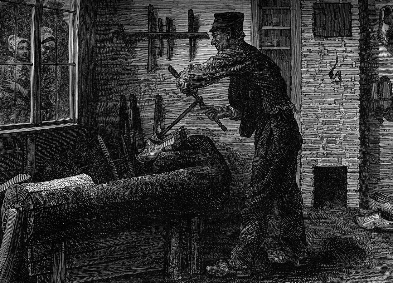Un zapatero trabajando en su taller en Bélgica. Grabado en el diario "La juventud" de Unknown artist