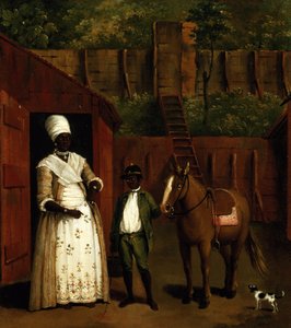 Una madre negra y su hijo con un pony fuera de un establo