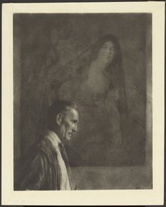 [Hombre con bigote pequeño y cuidado, de perfil, delante de un cuadro de una mujer vestida a la española].
