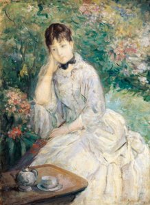 Joven mujer sentada en un sofá de Berthe Morisot