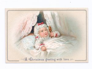 Tarjeta navideña victoriana de un niño en la cama sosteniendo un sonajero, c.1880 de English School