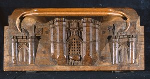 Una misericordia que representa el caballo de Sir Yvain atrapado mientras se baja la reja de entrada de un castillo elaborado, Capilla del New College, Oxford, finales del siglo XIV (madera)
