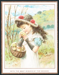 Niña oliendo flores de una cesta