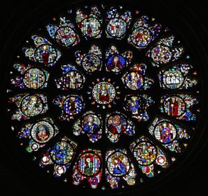 La ventana de rosetón oeste con paneles fragmentarios del siglo XV y XVI que representan principalmente a santos de French School