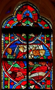 Ventana w209 que representa una escena de una leyenda de San Nicolás: un diablo da un líquido a unos viajeros pero el frasco se pierde por la borda