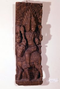 Agni, dios del fuego, representado con dos cabezas (bicefalo) sobre un carnero, según la mitología hindú. Escultura de madera del siglo XVII. París, Museo Guimet de Indian School