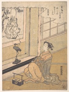 Una joven sentada en una habitación mirando un kakemono de Fukurokujin de Isoda Koryusai