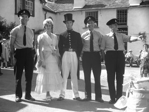 Hombres y mujeres disfrazados en Hawkshead Fayre delante de Mintrel