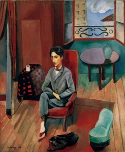 Jean Cocteau sentado en su estudio de Moise Kisling