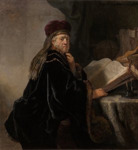 Un erudito sentado en un escritorio de Rembrandt van Rijn