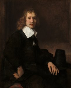 Un joven sentado en una mesa posiblemente Govaert Flinck, c. 1660 de Rembrandt van Rijn