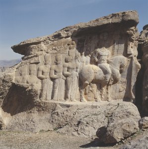 Relieve en roca que representa a Shapur I y su familia con emblemas heráldicos en sus sombreros, con una inscripción trilingüe en el caballo en griego, parto y persa medio