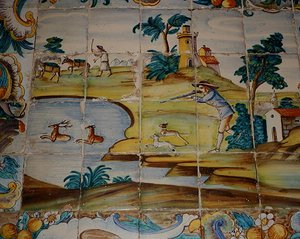 Azulejos que representan a un cazador disparando a un ciervo