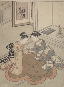Dos mujeres jóvenes sentadas junto a un kotatsu jugando a la cuerda, ca. 1765 de Suzuki Harunobu