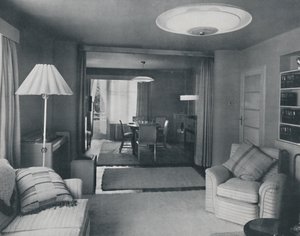 Comedor y sala de estar, divididos solo por cortinas pesadas en un tejido moderno atractivo, 1942 de Unbekannt