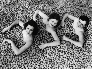 Tres jóvenes mujeres bañándose en un mar de nueces. América. 1932 de Unbekannt