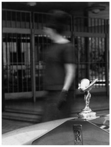 Mujer caminando junto a un Rolls-Royce de Unbekannt