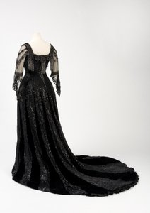 Vestido de noche negro usado por la Reina Alexandra, con decoración de cuentas y lentejuelas e incorporando la cinta de nombre de seda negra y letras doradas de la Reina Alexandra, hecho por Barolet de Knightsbridge, Londres 1908-1910