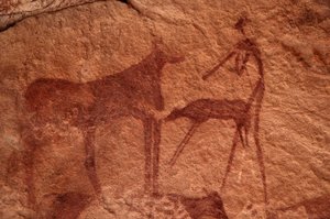 Arte rupestre, Prehistoria: Pintura rupestre de una vaca, ternero y personaje (arquero) en un refugio ornamentado, en el macizo de Uweinat, Egipto. (Periodo de 8000 a 3000 años a.C.). Fotografía de Unbekannt
