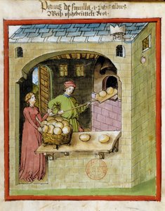 Elaboración de pan: un panadero hornea los panes de Unknown artist