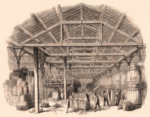Interior de una fábrica de tabaco: trabajadores cortando una bola de tabaco y otros involucrados en la fabricación y manejo de barriles de Unknown