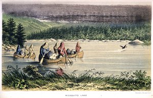 Lago Mosquito en Canadá: indios reman a través del lago con redes de mosquitos en la cabeza - en 